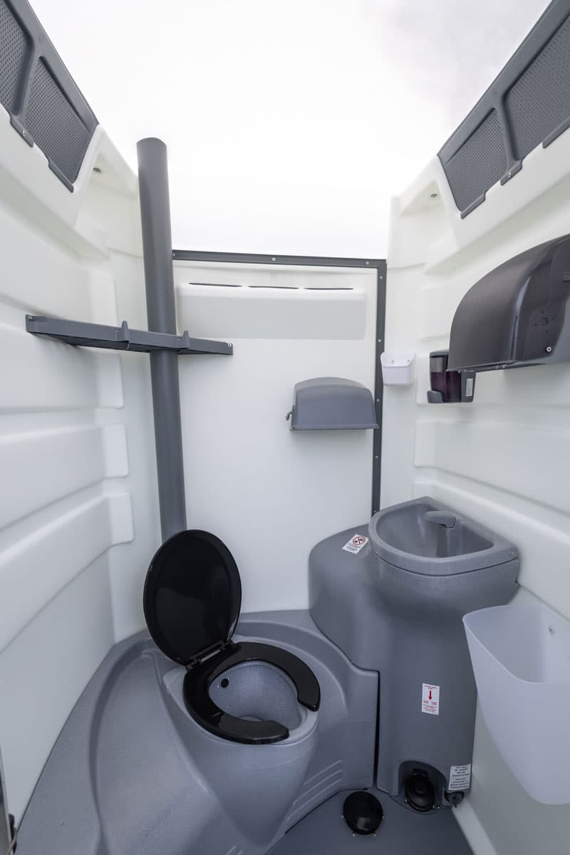 Portable restroom with built-in handwashing sink